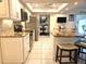 Kitchen with stainless appliances, granite countertops, white cabinets, and island with seating at 1706 S Lakeside Ct, Venice, FL 34293