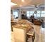 Open-concept kitchen featuring granite countertops and an island with seating at 1706 S Lakeside Ct, Venice, FL 34293