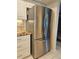 Modern kitchen featuring a stainless steel refrigerator and stylish white cabinetry at 1706 S Lakeside Ct, Venice, FL 34293