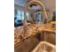 A kitchen sink with a stainless steel faucet, granite countertops, and a modern design at 1706 S Lakeside Ct, Venice, FL 34293
