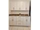 A kitchen features granite countertops, white cabinets, and stainless steel hardware at 1706 S Lakeside Ct, Venice, FL 34293
