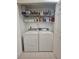 Laundry area with a full-size washer and dryer and shelving for storage at 1706 S Lakeside Ct, Venice, FL 34293