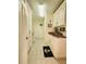 Bright laundry room with ample white cabinetry, granite countertops, and a black anchor rug at 1706 S Lakeside Ct, Venice, FL 34293