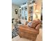 Comfortable chair and decorative bookcase in a cozy living space with unique decor at 1706 S Lakeside Ct, Venice, FL 34293