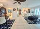 Open-concept living area with tile flooring, comfortable furniture, and nautical-themed decor at 1706 S Lakeside Ct, Venice, FL 34293