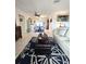 Spacious living room featuring nautical decor, tile floors, and comfortable white furniture at 1706 S Lakeside Ct, Venice, FL 34293