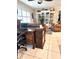 Home office space with a large desk, comfortable seating, and stylish shelving at 1706 S Lakeside Ct, Venice, FL 34293