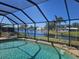 Lovely view of a tranquil lake beyond the screened-in pool at 1706 S Lakeside Ct, Venice, FL 34293