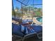 Enjoy poolside lounging with a tranquil lake backdrop beyond the screened lanai at 1706 S Lakeside Ct, Venice, FL 34293