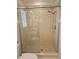 Bathroom shower features glass door, tiled walls, and chrome shower head at 1706 S Lakeside Ct, Venice, FL 34293