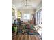 Bright sunroom with wicker furniture, tropical rug, and sliding glass doors for outdoor access at 1706 S Lakeside Ct, Venice, FL 34293