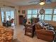 Cozy sunroom featuring a comfortable seating area and an abundance of natural light at 1706 S Lakeside Ct, Venice, FL 34293
