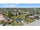 Aerial showing the home in a quiet neighborhood with tall trees and well kept lawns at 218 Soursop, Punta Gorda, FL 33955