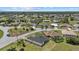 Aerial view of a neighborhood, showcasing the house's location within a community with mature trees at 218 Soursop, Punta Gorda, FL 33955