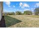 Serene backyard view showcasing an expansive lawn with mature landscaping, offering privacy at 218 Soursop, Punta Gorda, FL 33955