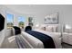 Comfortable bedroom boasts plush seating, a comfy bed and an abundance of natural light at 218 Soursop, Punta Gorda, FL 33955