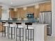 Modern kitchen with stainless steel appliances, pendant lighting, and breakfast bar seating at 218 Soursop, Punta Gorda, FL 33955