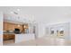 Bright living area featuring tile flooring, recessed lighting, a kitchen, and large windows at 218 Soursop, Punta Gorda, FL 33955