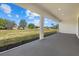 Wide screened-in lanai showcasing serene views of the expansive lawn and neighboring properties at 218 Soursop, Punta Gorda, FL 33955