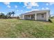 Back exterior of the house, showing patio and expansive yard with lush tropical landscaping at 218 Soursop, Punta Gorda, FL 33955