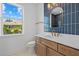 Bathroom boasts modern fixtures, bright window, and stylish blue tiled wall at 349 Gold Tree, Punta Gorda, FL 33955