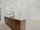 Spacious kitchen island features modern pendant lights and an open layout, perfect for entertaining at 349 Gold Tree, Punta Gorda, FL 33955