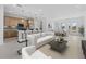 Open living space showcasing a modern kitchen with bar seating, dining area, and a comfortable living room with large windows at 349 Gold Tree, Punta Gorda, FL 33955