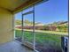 Screened-in porch with a view of the home's yard and surrounding greenery at 37613 Daliha Ter, Zephyrhills, FL 33542