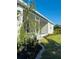 Landscaped backyard with a screened-in porch and tropical plants at 7343 N Ficus Tree, Punta Gorda, FL 33955