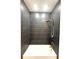 Bathroom featuring a shower over tub with a white interior and black tile surround with brass fixtures at 7343 N Ficus Tree, Punta Gorda, FL 33955