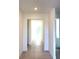 Bright hallway with tile flooring, neutral walls and a door leading to a carpeted room at 7343 N Ficus Tree, Punta Gorda, FL 33955