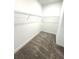 Walk-in closet featuring neutral colored carpet, white walls and wire shelving at 7343 N Ficus Tree, Punta Gorda, FL 33955