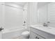 Bright bathroom featuring a shower over tub, vanity with a quartz countertop, and modern fixtures at 1844 Draughton Dr, Zephyrhills, FL 33541