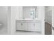 Elegant bathroom featuring double vanity sinks, ample counter space, and modern finishes at 1844 Draughton Dr, Zephyrhills, FL 33541