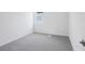 Bedroom features plush carpet, a window with natural light, and neutral paint at 1844 Draughton Dr, Zephyrhills, FL 33541