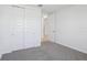 Cozy bedroom featuring a closet with sliding doors and plush carpeting at 1844 Draughton Dr, Zephyrhills, FL 33541