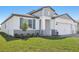 Charming single-Gathering home featuring a manicured lawn, well-maintained landscaping, and an attached two-car garage at 1844 Draughton Dr, Zephyrhills, FL 33541