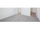Hallway features plush carpet, neutral paint, and doors on both sides at 1844 Draughton Dr, Zephyrhills, FL 33541