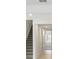 Hallway with staircase, light colored hardwood flooring and white walls at 1844 Draughton Dr, Zephyrhills, FL 33541