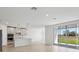 Open-concept kitchen with sleek countertops, modern appliances, and abundant natural light from the sliding glass doors at 1844 Draughton Dr, Zephyrhills, FL 33541