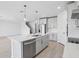 Spacious kitchen featuring a large island with a sink, modern appliances, and stylish pendant lighting at 1844 Draughton Dr, Zephyrhills, FL 33541