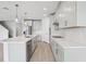 Modern kitchen with stainless steel appliances, white cabinets, and spacious island at 1844 Draughton Dr, Zephyrhills, FL 33541