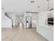 Bright, open-concept living space featuring sleek flooring, neutral walls, and modern stainless steel appliances at 1844 Draughton Dr, Zephyrhills, FL 33541