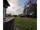 Large backyard with lush green grass and mature trees, providing ample space for outdoor activities at 201 Ravenna N St, Nokomis, FL 34275