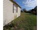 View of backyard including a side of the house and some greenery at 201 Ravenna N St, Nokomis, FL 34275
