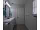 Bathroom featuring modern vanity with white countertop, black faucet, and framed mirror at 201 Ravenna N St, Nokomis, FL 34275