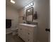 Bathroom with a white vanity, black fixtures, and a modern mirror at 201 Ravenna N St, Nokomis, FL 34275