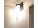 Bathroom light with frosted shade and a black base at 201 Ravenna N St, Nokomis, FL 34275