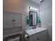 Bathroom featuring white vanity with a mirror, and built-in toilet cabinet at 201 Ravenna N St, Nokomis, FL 34275