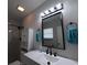 A modern bathroom with a large mirror, white vanity, and stylish fixtures and shower at 201 Ravenna N St, Nokomis, FL 34275
